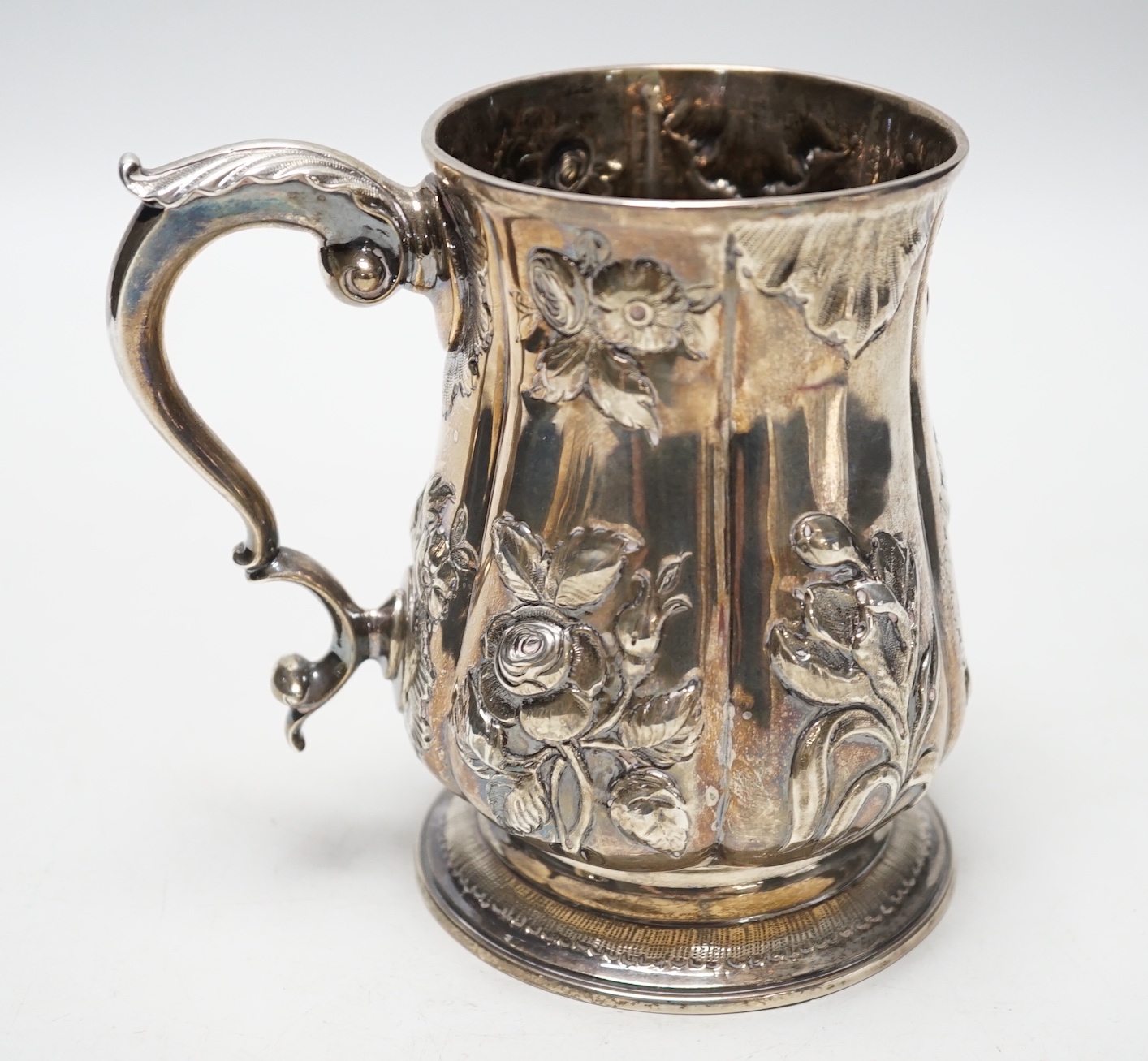 A George III silver baluster mug, with later embossed decoration, Joseph Steward?, London, 1763, 12.9cm, 11.8oz.